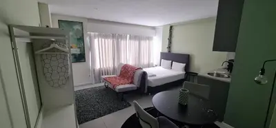 a hotel room with a bedroom with a bed and a table at Green Studio in Porto