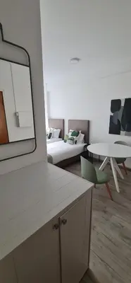 a living room with a couch and a table at Green Studio in Porto