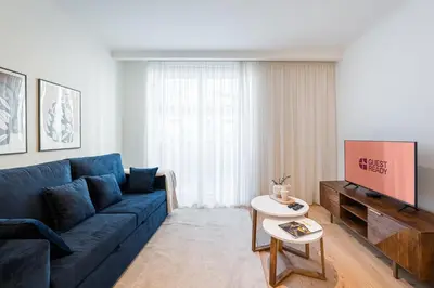 a living room with a blue couch and a table at GuestReady - A peaceful home near downtown in Porto