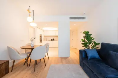a living room with a blue couch and a table at GuestReady - A peaceful home near downtown in Porto