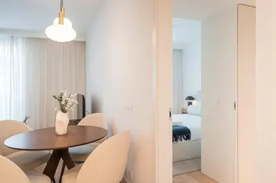 a room with a table and chairs and a bedroom at GuestReady - A peaceful home near downtown in Porto