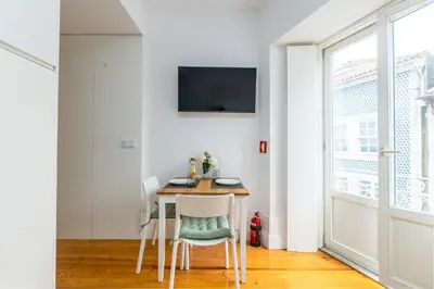 a small dining room with a table and chairs at A Window to Porto - Premium Studio at Clérigos Tower in Porto