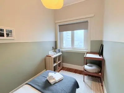a bedroom with a bed and a desk and a window at Porto Vintage House in Porto