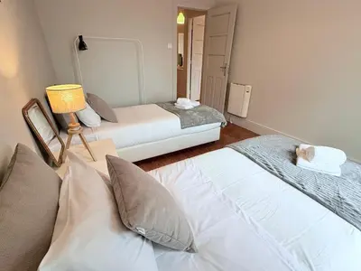 a hotel room with two beds and a lamp at Porto Vintage House in Porto