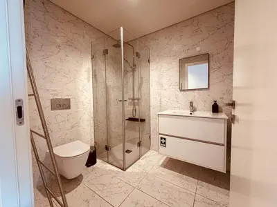 a bathroom with a shower and a toilet and a sink at Paraíso P in Porto
