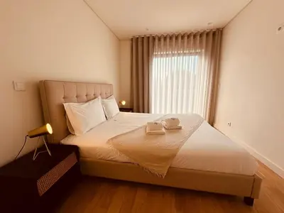a bedroom with a bed with two towels on it at Paraíso P in Porto