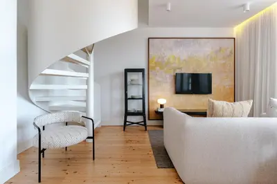 a living room with a couch and a tv at Feel Porto Clerigos Charm Flats in Porto