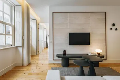 three chairs and a table on a balcony with a view at Feel Porto Clerigos Charm Flats in Porto