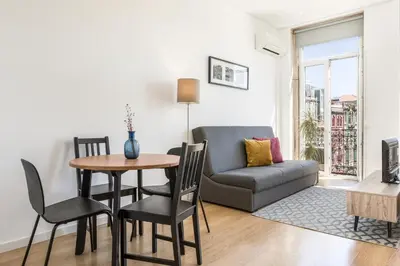 a living room with a couch and a table and chairs at Apartment Bolhao Market by Sweet Porto in Porto