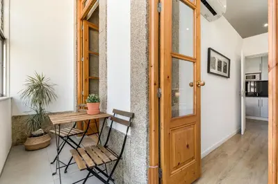 a room with a wooden table and a wooden door at Apartment Bolhao Market by Sweet Porto in Porto