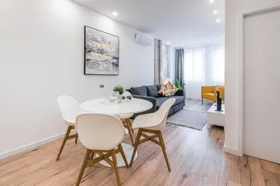 a living room with a white table and chairs at GuestReady - Picaria Graffiti in Porto
