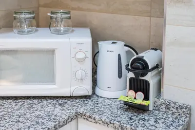a microwave and a toaster on a kitchen counter at GuestReady - Cedofeita Cradle in Porto