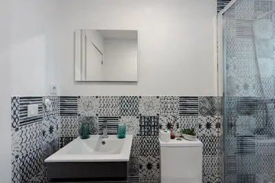 a bathroom with a sink and a toilet and a mirror at Bonfim Apartment by Best2Stay in Porto