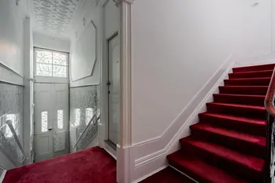 a staircase with a red carpet and a red rug at Bonfim Apartment by Best2Stay in Porto