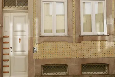 a building with two windows and a white door at Breiner Apartment, Arts District in Porto