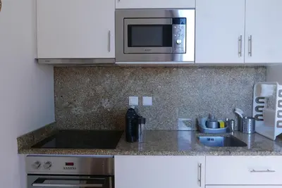 a kitchen with a sink and a microwave at Breiner Apartment, Arts District in Porto