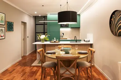 a kitchen and dining room with a table and chairs at Porto Insight Apartments- with balcony in Porto