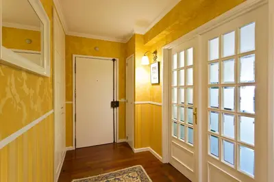 a hallway with yellow walls and a white door at VIVA Belos Ares in Porto