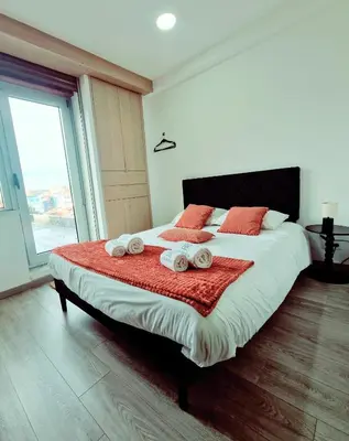 a bedroom with a large bed with towels on it at Alma de Cedofeita Apartment in Porto