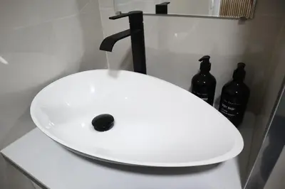 a white sink with a faucet and two bottles at Alma de Cedofeita Apartment in Porto