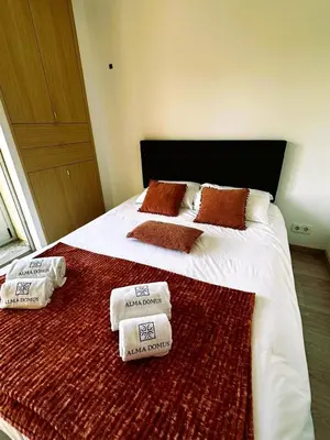 a bedroom with a bed with two towels on it at Alma de Cedofeita Apartment in Porto