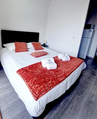 a bedroom with a large bed with towels on it at Alma de Cedofeita Apartment in Porto