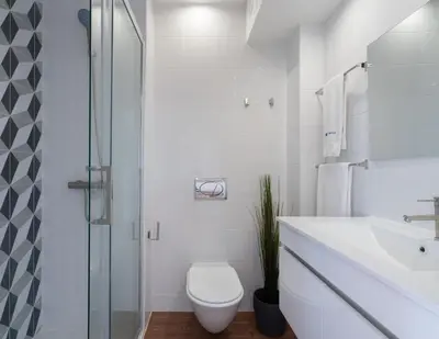 a white bathroom with a toilet and a sink at Host Wise - Sunny Bright Flat w Balcony in Porto