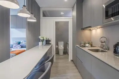 a kitchen with a sink and a room with a bed at Ribeira Apartments Baixa in Porto