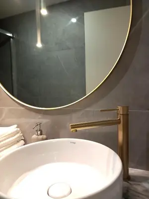 a bathroom with a large mirror and a tub at Fontinha House in Porto