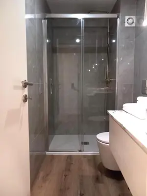 a shower with a glass door in a bathroom at Fontinha House in Porto