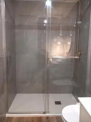 a shower with a glass door in a bathroom at Fontinha House in Porto