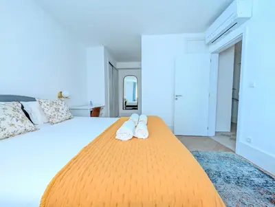 a bedroom with a bed with two towels on it at dvnest - Premium 1BR Apartment Designed for Remote Work in Porto
