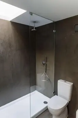a bathroom with a toilet and a glass shower at Wood & Blue House - Porto in Porto