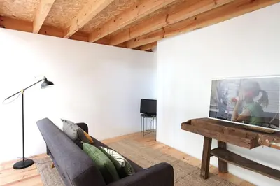 a living room with a couch and a piano at Wood & Blue House - Porto in Porto