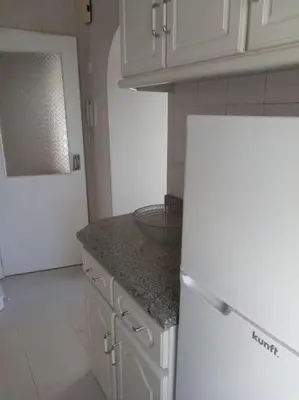 a kitchen with white cabinets and a granite counter top at Lulapartment III in Porto