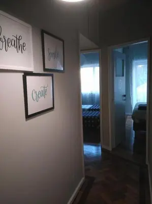 a hallway with pictures on the wall of a room at Lulapartment III in Porto