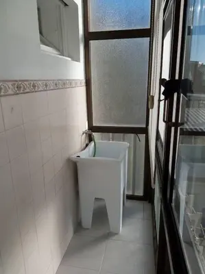 a bathroom with a white sink and a window at Lulapartment III in Porto