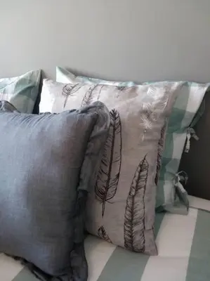 a group of pillows sitting on top of a bed at Lulapartment III in Porto