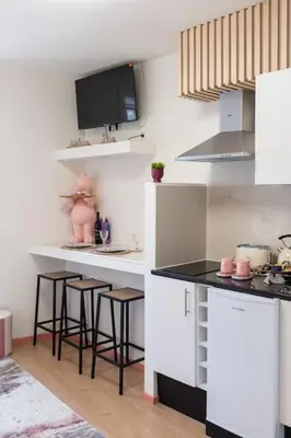 a kitchen with a counter and stools in a room at The Charm Bonfim OPO in Porto