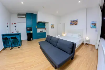a large bedroom with a bed and a couch at Bonsai Apartment 6 in Porto