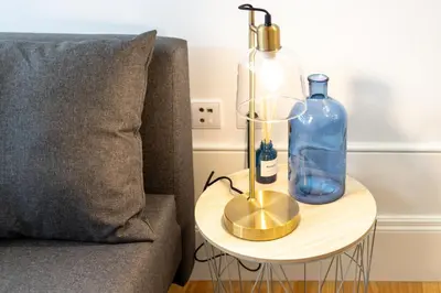 a side table with a bottle on it next to a couch at Formosa Studios by Upperground in Porto
