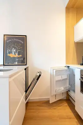 a kitchen with white cabinets and an open refrigerator at Oporto Vibes - T1 Moderno no Centro do Porto com AC, by HopStays in Porto