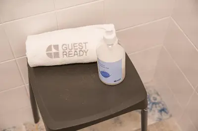a bottle of detergent sitting on a table in a bathroom at GuestReady - Oporto Vintage in Porto