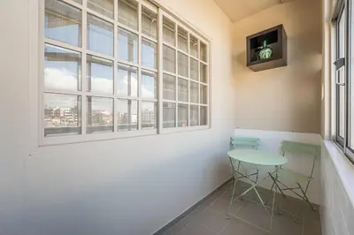 a table and two chairs in a room with a window at GuestReady - A charming duplex home near Boavista in Porto