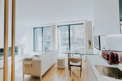 a living room with a couch and a table at VIVA Formosa Lofts in Porto