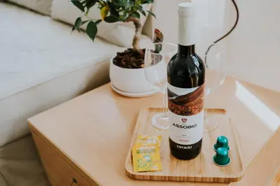 a bottle of wine and glasses on a table at VIVA Contemporary Duque Terceira in Porto