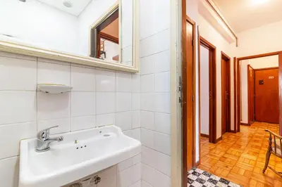 a dining room and living room with a table and chairs at Bonfim Sunny Vintage apartment in Porto
