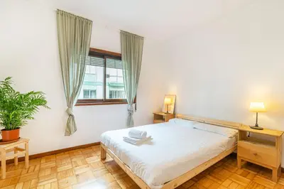 a bedroom with a bed and a window at Bonfim Sunny Vintage apartment in Porto