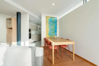 a kitchen and dining room with a table and chairs at Host Wise - Bright and Cozy House with Dom Luís Bridge View in Porto