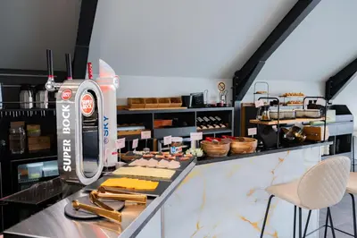 a bakery with a counter with food on it at Smartr Porto Reis de Gaia & Spa in Vila Nova de Gaia